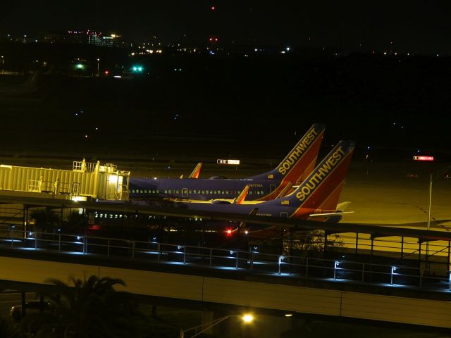 Boeing 737-700 (N7738A) - Airside "C". Southwest N966WN 737-7H4 in the foreground. Taken from room 402 of the Marriott Tampa Airport.