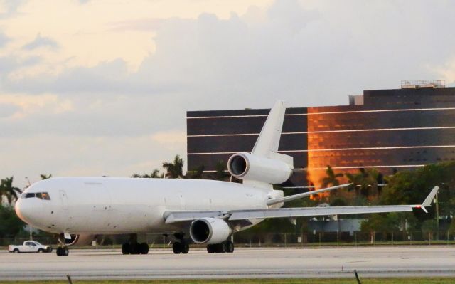 Boeing MD-11 (N512JN) - The Sunset"Relecting off the buildings façade!