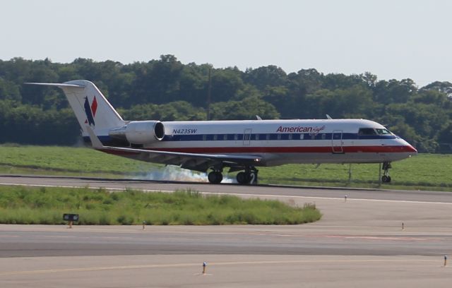 Canadair Regional Jet CRJ-200 (N423SW) - An American Eagle Bombardier CL-600-2B19 (CRJ2), operating as SkyWest 2914, at touchdown on Runway 36L at Carl T. Jones Field, Huntsville International Airport, AL - July 9, 2017. The photos backlit, but Im much closer to the runway at this location at HSV for this size jet than I would be on the other side of the aircraft. 