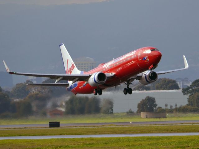 Boeing 737-700 (VH-VUI) - Getting airborne off runway 23 on a cold, gloomy winters day. Wednesday 4th July 2012.