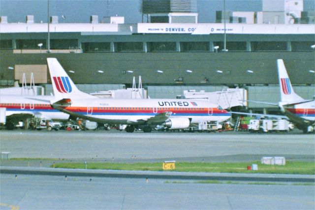 BOEING 737-300 (N326UA) - Denver Stapleton Aug 1988 - one summer the wife picked the driving trip around the USA from the SJC area - we headed EB 80 to SLC, then over to Dinosaurland in Vernal UT as my young son was into Dinosaurs then, then to Rocky Mtn Natl Park, walked around at 11,000ft level, fun, then down to Estes Park, CO and over to Denver for 3 days. I whined for time at Stapleton. The ex liked to sleep in so Lil Alien and I burned east from Wheatland spent 3 hours in the AM with our mouths open agog at the air traffic at Stapleton.....15 CO 727s, followed by 15 UAL 727s, followed by 10 737-200s both CO.UAL mixed in with a few UAL DC-10s and then silence for 25 minutes,,,then everybody would take off, and then the traffic started landing again...it's so flat east out of Denver we could see jet headlights for 20 miles out all lined up. We didn't have access to the photo platform, but I'm tall enough I can stand and film over the fence. If you never made it to Stapleton viewing area - you missed it! This photo here is a 1000mm Celestron Lens with Minolta XD-11 hand held about ,25 miles away. I wish i could go back in time.....