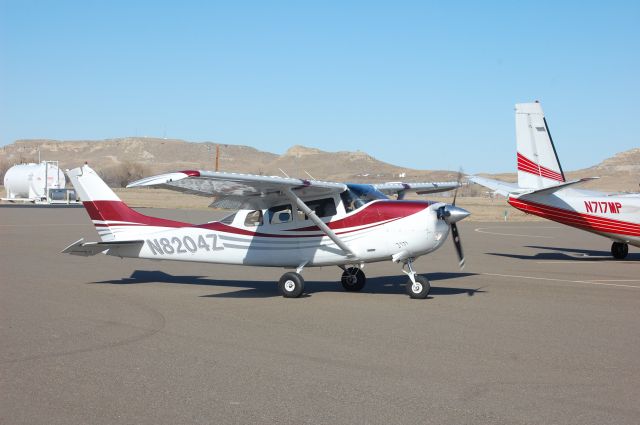 Cessna 205 (N8204Z) - On the ramp next to a Commander