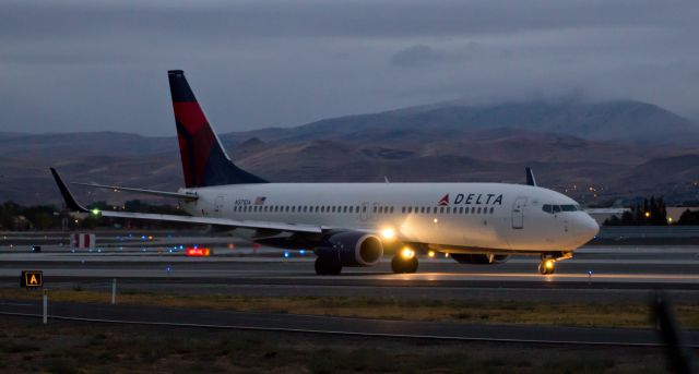 Boeing 737-800 (N371DA) - As dawn breaks under overcast skies over the Truckee Meadows, DALs N371DA moves along taxiway Alpha toward runway 34L for a departure to KSLC.