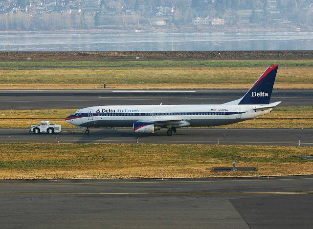 Boeing 737-800 (N377DA) - KPDX - Feb 2005 photo of a delta 737-800 being towed from the remote slot over to the terminal. The Columbia River seperates Washington State from Oregon in this early AM photo at Portland.