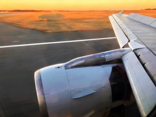 Airbus A319 (N704US) - Rolling out on runway 33L as the sun sets on Baltimore.  Arriving as AA1752 from Charlotte.  Taken from seat 9F.