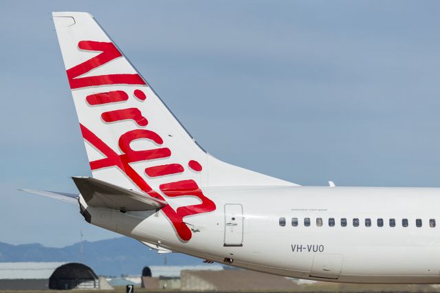 Boeing 737-700 (VH-VUO) - Close up detail of tail section of a B738. Note the outflow valve in the open position below rear door passenger exit. As the aircraft gains altitiude, this door will slowly close, but not completely shut, which allows the passenger cabin and flight deck  to pressurise, allowing passengers to breathe at a comfortable atmospheric pressure of about 7000ft. The final figure depends on final cruise altitude, ultimaterly keeping the pressure differential for the fuselage structure within safe limits.