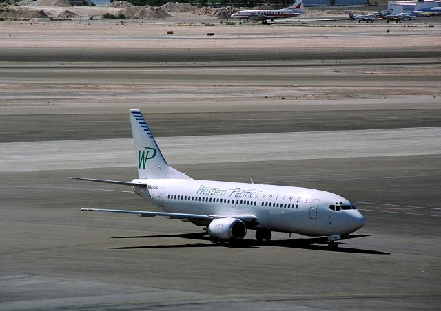 BOEING 737-300 (N948WP) - KLAS - July 1995 shows Western Pacific 737-300 arriving at the gates. It was a mere 115 degrees this day!