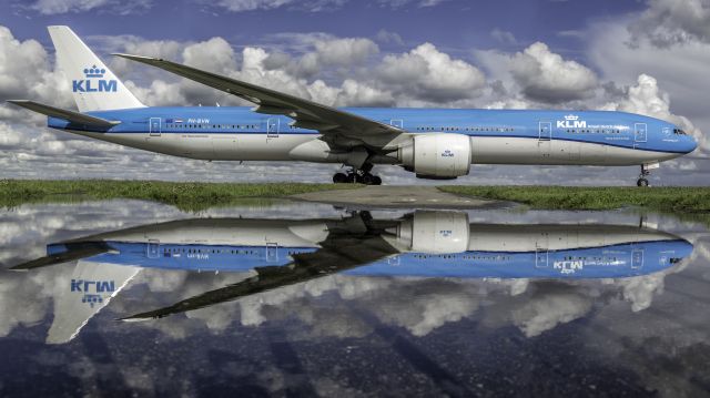 BOEING 777-300 (PH-BVN) - Reflecting in a flooded service road.