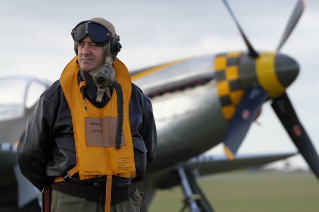 — — - Duxford Air Museum annual Flying Legends, provides a great opportunity to capture a variety of war bird aircraft from a bygone era. Here we see a volunteer wearing a uniform from the WWII period.