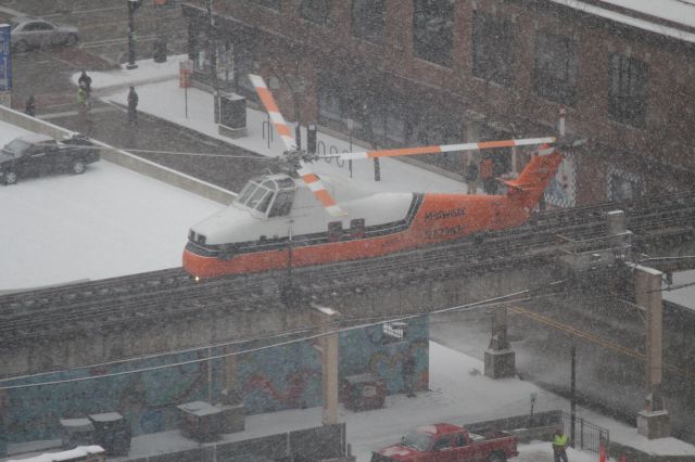 N129NH — - Construction work in snowstorm in downtown Chicago.  Intersection of 7th and Wabash and Chicago Transit Authority elevated track in background.