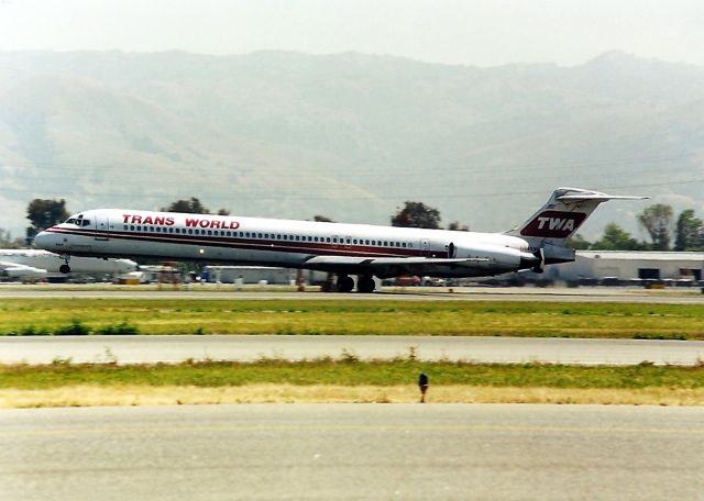 McDonnell Douglas MD-80 (N9403W) - KSJC- China built TWA MD-80 landing 30 L at SJC in May 1999. Note the engine thrust diverters fully deployed as this skilled TWA Pilot eases this Mad Dog onto the runway with no 'slam down' effect as the nose gear is still up with thrust reversers deployed....cool!