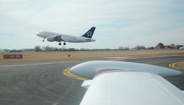 Airbus A319 (N1116A) - A319 taking off 18L off the right wing of N1116A after landing - taxing back to Wilson Air Center