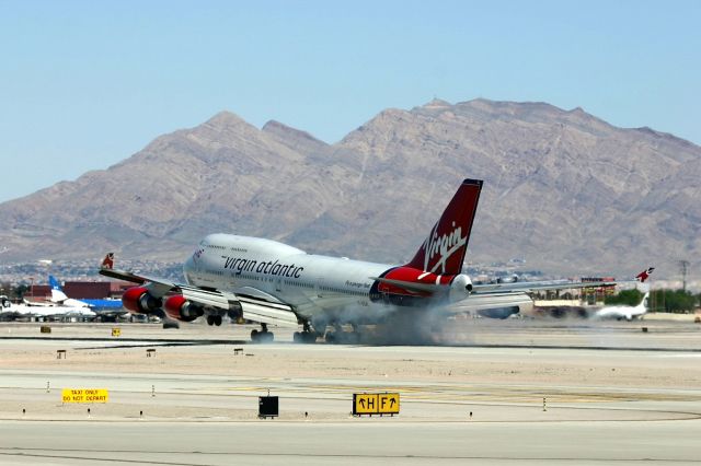 Boeing 747-400 (G-VGAL) - KLAS - "Jersey Girl" landing on a hot April 01. 2005 in Las Vegas, smokin those tires with the extra weight of big fat wallets arriving in the gambling mecca. This jet cn:32337/1272 and poss was destined for Alitalia when new as EI-CVH - but flown by Virgin Atlantic for many years.