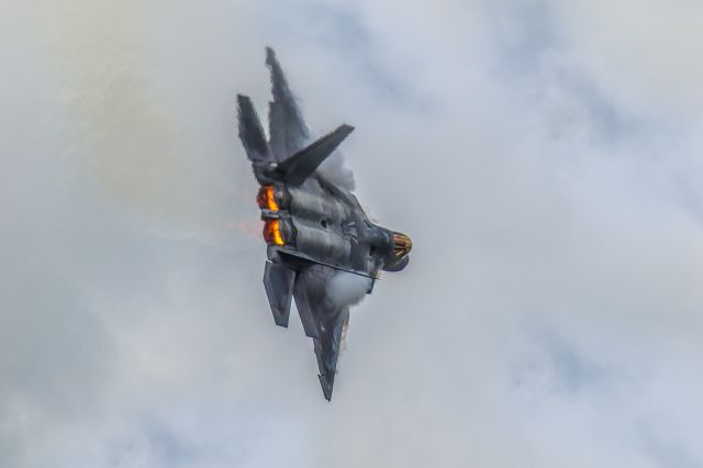 Lockheed F-22 Raptor — - The F22 Raptor photographed was doing a demonstration performance at the Sun N Fun Aerospace Expo in Lakeland Florida April 2021. I think this photo is an amazing capture of this magnificent machine. With the afterburners engaged and emitting spectacular color then adding vapors forming over the wings, that gave the opportunity to get what I feel is a great photo. I used 600mm of Canon lens and the camera settings were 1/8000 F5.6 ISO 500. Please check out my other photography. Positive votes and comments are greatly appreciated. Questions about this photo can be sent to Info@FlewShots.com