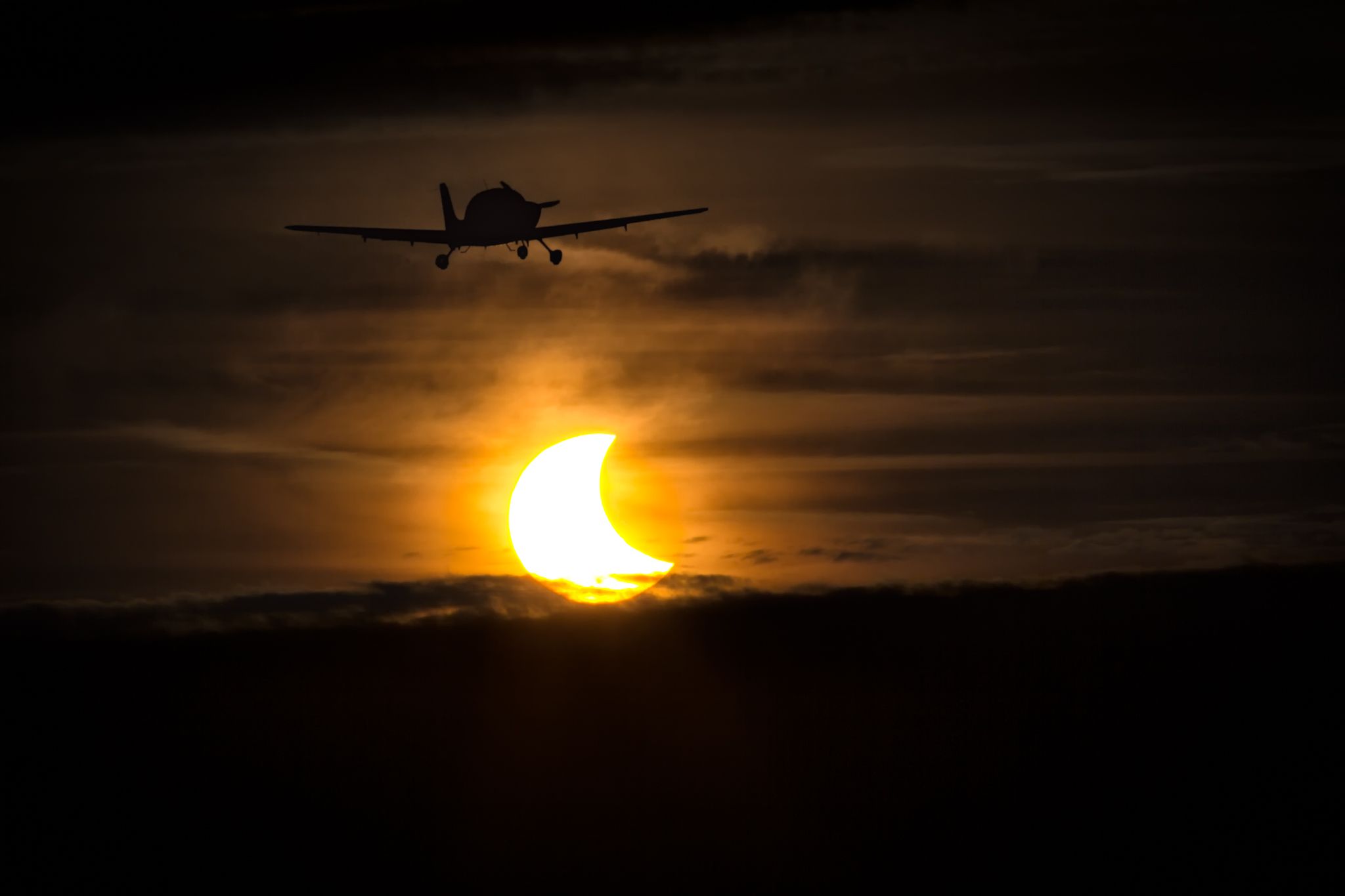 Cirrus SR-20 — - A Cirrus departing Pontiac Airport during the height of the Oct. 23 Solar Eclipse.br /br /a rel=nofollow href=http://www.adler-photo.comwww.adler-photo.com/a