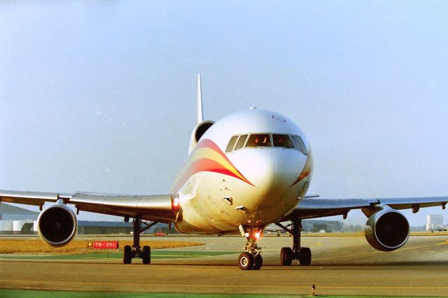 Lockheed L-1011 TriStar (N104CK) - KLAX - American Intl Airlines L-1011 Freighter rolling off 25L right in front of us at the old Imperial Terminal parking lot - dating this photo to 1990-ish. Usually when we were here the jets would turn early farther to the right of roll past us to the end and taxi back,,,,it does not look like John Lear in the drivers seat....