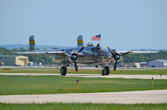 North American TB-25 Mitchell (N27493) - Deke Slayton Airfest June 2014. B-25 Miss Mitchell taxiing with flag displayed.