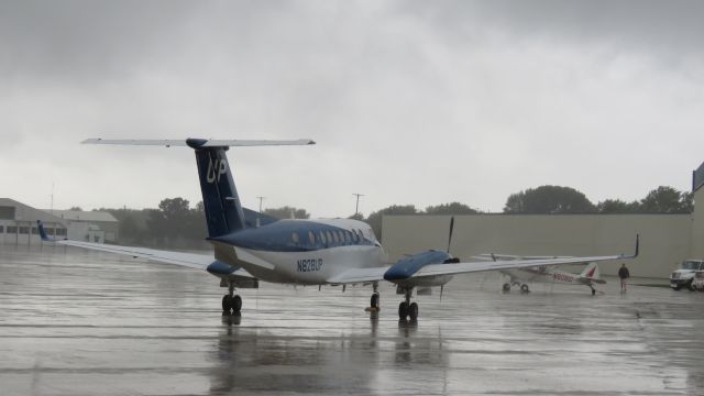 Beechcraft Super King Air 350 (N828UP) - On a wet and rainy ramp at KOSH