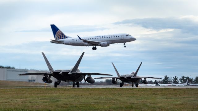 Lockheed F-22 Raptor (07151) - These two F-22s lined up together on the taxiway while a United Airlines E170 flew in. Very cool to see.