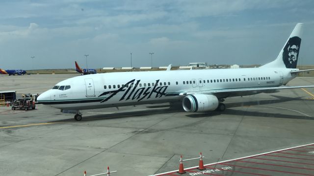 Boeing 737-900 (N457AS) - Alaska pulling into the gate in Denver, my view while having a beer :)