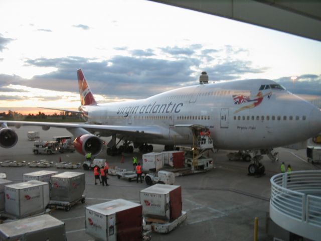 Boeing 747-400 (G-VTOP) - After arrival at KMCO Orlando, Florida from the UK, cargo containers are off loaded.