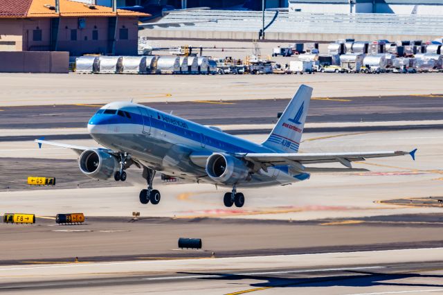 Airbus A319 (N744P) - An American Airlines A319 in Piedmont retro livery taking off from PHX on 2/24/23. Taken with a Canon R7 and Canon EF 100-400 ii lens.