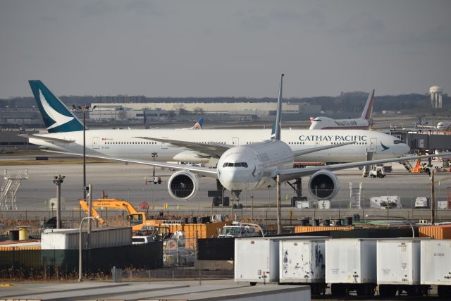 BOEING 777-300 (B-KGG) - Wait, is this Hong Kong, or ORD? A Double shot of CX at ORD, with a Connie lurking in the background.