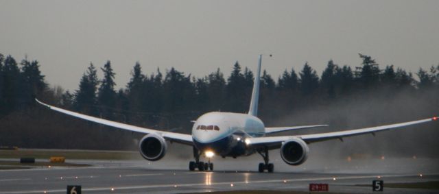 Boeing 787-8 (N787BA) - 787 nosewheel just coming up off the runway on her maiden flight.