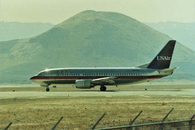 BOEING 737-300 (N534AU) - KRNO - With Gary 'Gman" Schenauer's "Rattlesnake Hill" looming in the distance, USAir 737 set to depart Reno,NV for most likely Pittsburg,PA or Philly. I didn't know the routing back then and still don't. This photo date apprx June 1990 on a trip to visit relatives in Carson City.