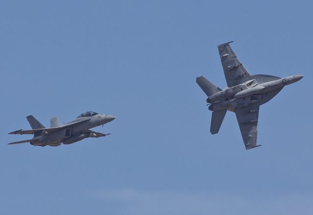 McDonnell Douglas FA-18 Hornet — - Pair of F-18 Super Hornets from VFA-103, the Jolly Rogers, arriving to NAS/JRB Fort Worth as part of the 21 aircraft flyover salute to former President George H.W. Bush. 30 Super Hornets arrived at NFW while 21 took part in the flyover. The other 9 Rhinos orbited as alternates if needed during the fly over. RIP 41. (please view in "full" for highest image quality)