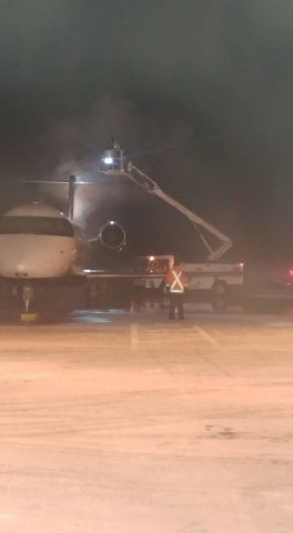 Canadair Regional Jet CRJ-200 (C-GJZZ) - Myself, in the bucket giving AC8885 a Type I spray on a cold winter evening.