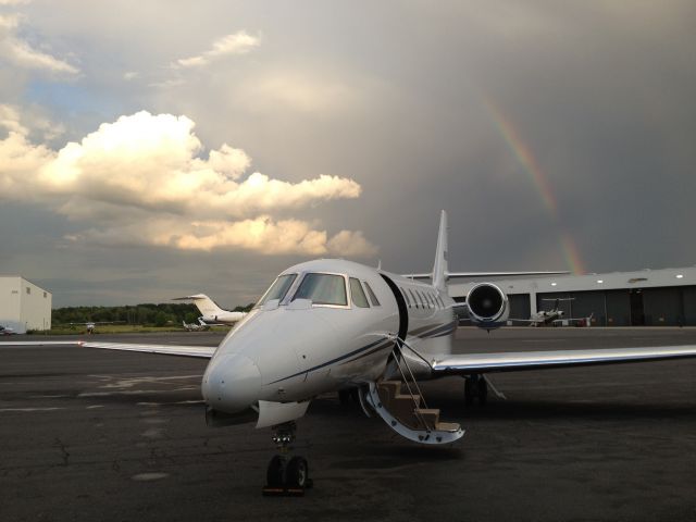 Cessna Citation Sovereign (N626CS) - Citation Sovereign after landing with a thunderstorm and rainbow over NY city.