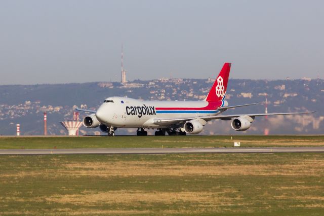 BOEING 747-8 (LX-VCB) - LX-VCB is taxiing back from RWY 31R on a sunny morning in Budapest. The city actually lies in the valley between the aircraft and the hills of Buda in the background where you can see the TV tower of Széchenyi hill...