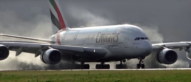 Airbus A380-800 (A6-EOJ) - A wet landing early in the morning. The dramatic look of the water spray from the Thrust reversal & the tire smoke make this shot what it is.