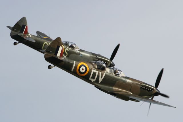 — — - A Supermarine Spitfire and Hawker Hurrican,perform a flypast at Duxford Air Museum.