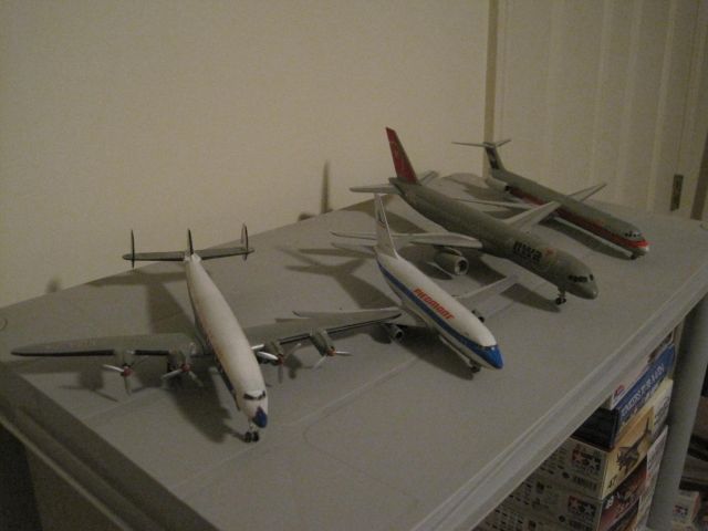 — — - Here are four 1/144 scale model airliners.  A Lockheed Super Constellation in Eastern markings, a Boeing 737-200 in Piedmont colors, a Boeing 757-200 in Northwest markings and a USAir McDonnell-Douglas MD-80.