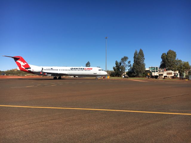 Fokker 100 (VH-NHG) - VH-NHG parked bay 2 @ YFDF in front of retired surface miner on static display 