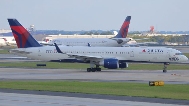 Boeing 757-200 (N694DL) - October 6, 2018 -- Delta 2111 taxis out to runway 9L for departure to Tampa, as Delta 82 (N803NW), an Airbus A332, is departing 9L for Paris, France.