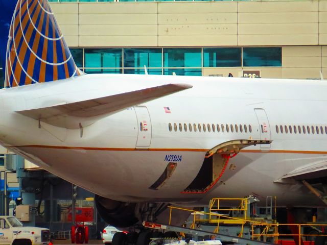 Boeing 777-200 (N215UA) - Loading the beast of burden, at Denver International on October 20, 2013