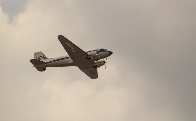 Douglas DC-3 (N814CL) - Clay Lacy's DC-3 flying westbound out of Long Beach Airport on Sunday, July 27, 2014. Dubbed" Mainliner O'Connor"; in honor of Mary O'Connor, one of United Airlines first flight attendants. O'Connor had a fascinating aviation career: see "http://navymedicine.navylive.dodlive.mil/archives/4717 and her book: Flying: The Story of a Pioneer Stewardess