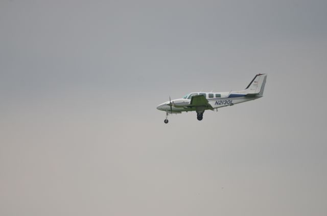 Beechcraft Baron (58) (N2130L) - Arrival to Oshkosh Airventure 2018 on runway 36