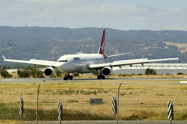 Airbus A330-300 (VH-QPD) - Turning on to the taxi-way, heading for Terminal 1, after landing on runway 23 on arrival from Sydney en-route to Singapore, on the last day of the Australian summer. Thursday 28th February 2013.