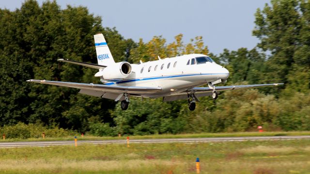 Cessna Citation Excel/XLS (N590AK) - Low over the threshold.