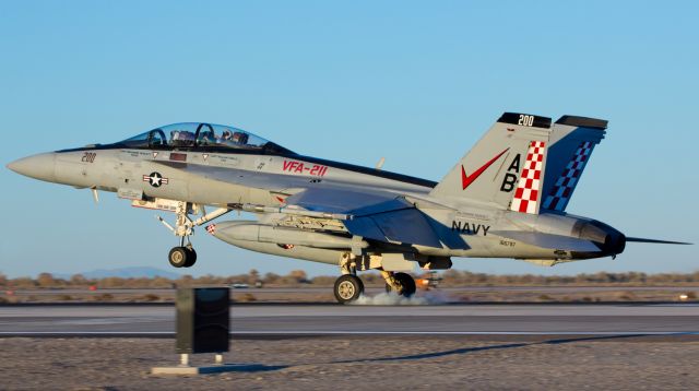 McDonnell Douglas FA-18 Hornet (16-6797) - The two equally timed and small puffs of rubber smoke coming from the tires of the Strike Fighter Squadron Two Eleven (VFA-211) CAGs F/A-18F Super Hornet, 166797, as they kiss the concrete of runway 31L show how expertly this Fighting Checkmates Super Bug was touched down as the sun was going down over NAS Fallon.