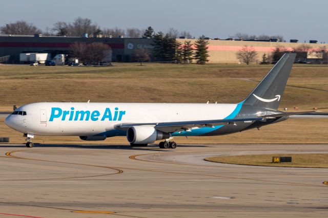 BOEING 767-300 (N1409A) - A Prime Air 767 sporting a nice pair of CF6s taxis with the GE Aviation building in the background.