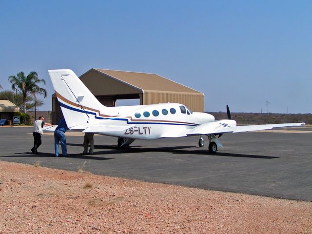 Cessna Chancellor (ZS-LTY) - At the Venetia Diamond mine, South Africa. Note the "drive thru" hangar.