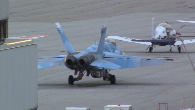 McDonnell Douglas FA-18 Hornet (16-4066) - An NSAWC F/A-18C Hornet in aggressor paint sits on the Lane Aviaion ramp at CMH. This Hornet came in as part of a flight of 2 using the callsign TOPGUN51