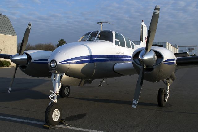 Beechcraft Twin Bonanza (N3640B) - A rare Twin Bonanza catches the sun rise in it's prop. This bird is a very lucky catch; manufactured in 1954.. The writing below the cockpit says 'The Spirit of Freedom 2 Fly'. March 2013