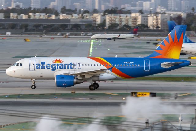 Airbus A319 (N320NV) - 25th January, 2024: East Imperial Ave view of Allegiant Air Airbus A319 (N320NV) taxiing to the gate after touching down on runway 25L at LAX.  This aircraft was formerly registered to the low cost carrier EasyJet as G-EZIP.