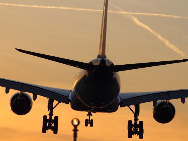 Airbus A330-200 — - Vapour trails criss cross the sky as an Oman Air A330-200 approaches the flare on runway 027R at LHR.